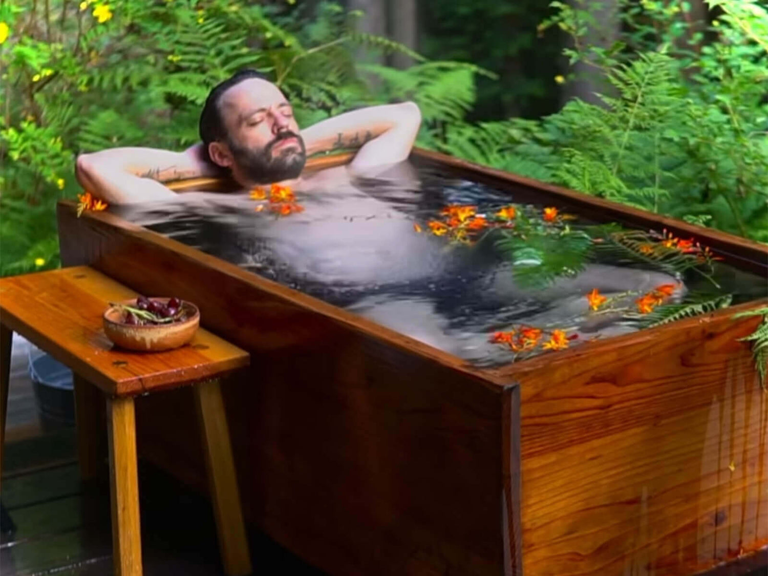 A man enjoys lying in an Ofuro bathtub
