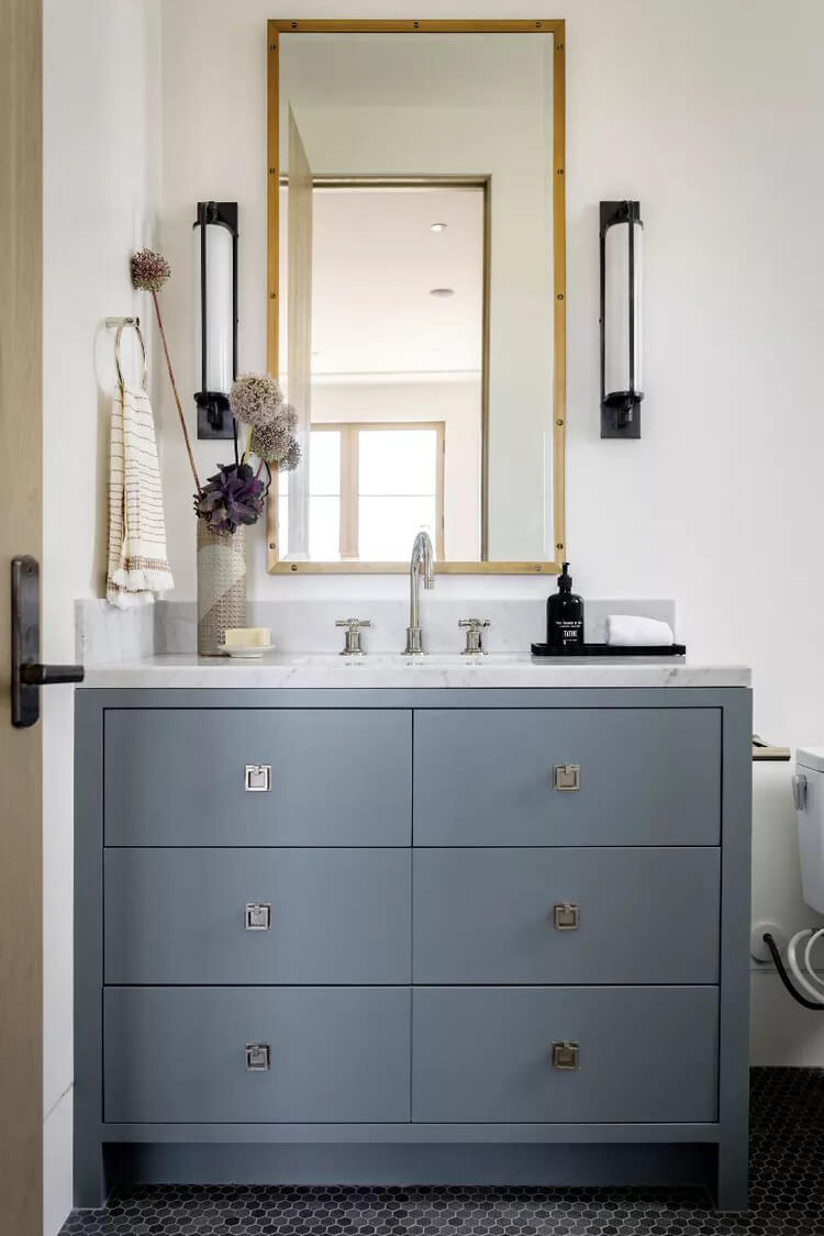 Blue-gray cabinets paired with light wood accents, sleek nickel hardware, and marble countertops