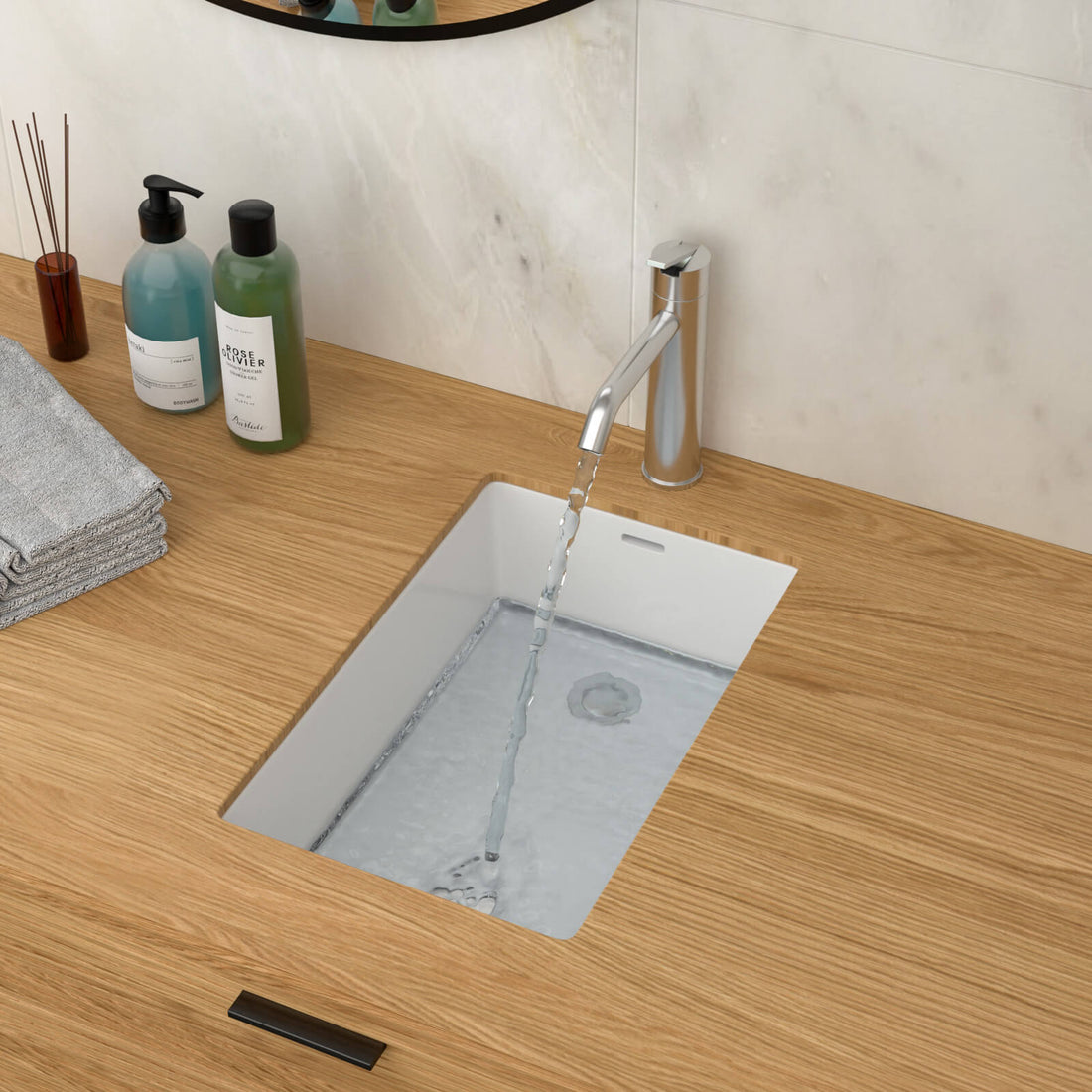 Compact width bathroom sink for space saving installation