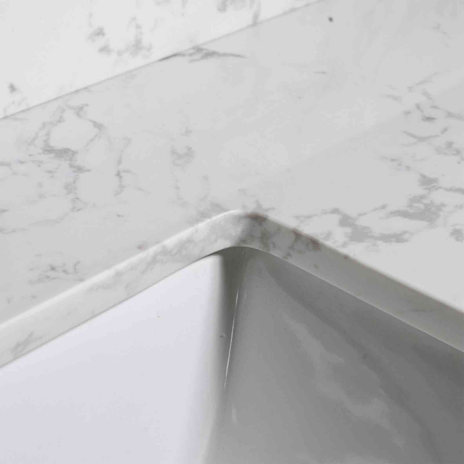Corner detail of a 43 x 22 Carrara marble vanity top sink with 3 faucet holes