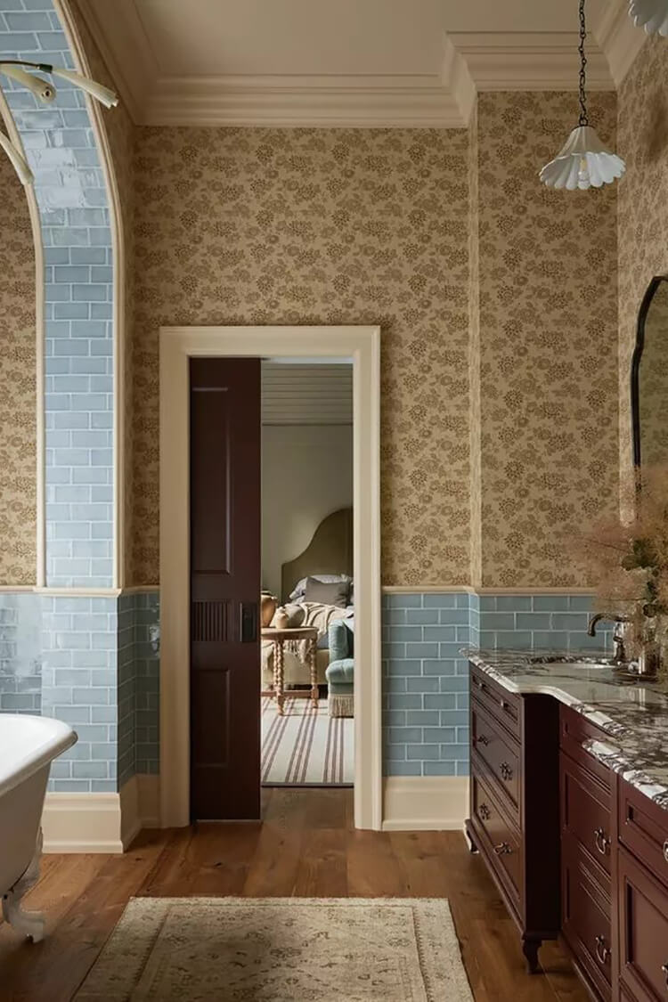 Dark brown bathroom cabinetry paired with soft blue tiles and golden-yellow wallpaper, creating a warm, elegant, and inviting bathroom atmosphere