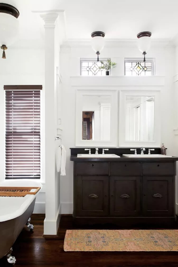 Dark wood cabinetry paired with dark wood flooring, while crisp white walls provide a clean, bright contrast