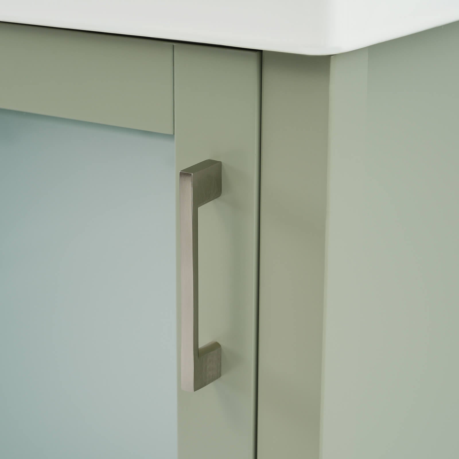 Door handle detail of a 20 inch green dresser with frosted glass door