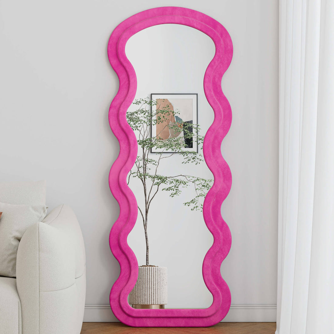 Pink wavy flannel mirror reflecting plant and art in living room