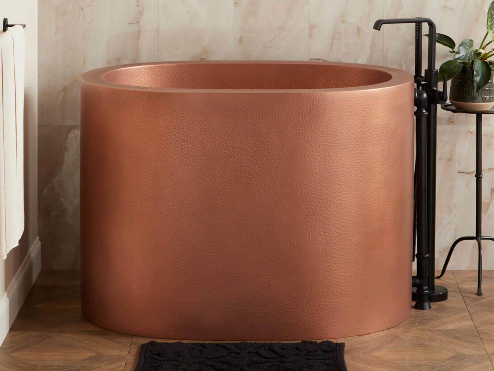 The copper Japanese soaking tub has a yellow exterior