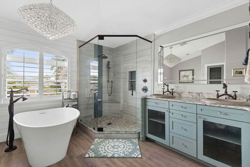The light grey teal vanity seamlessly blends into the bathroom