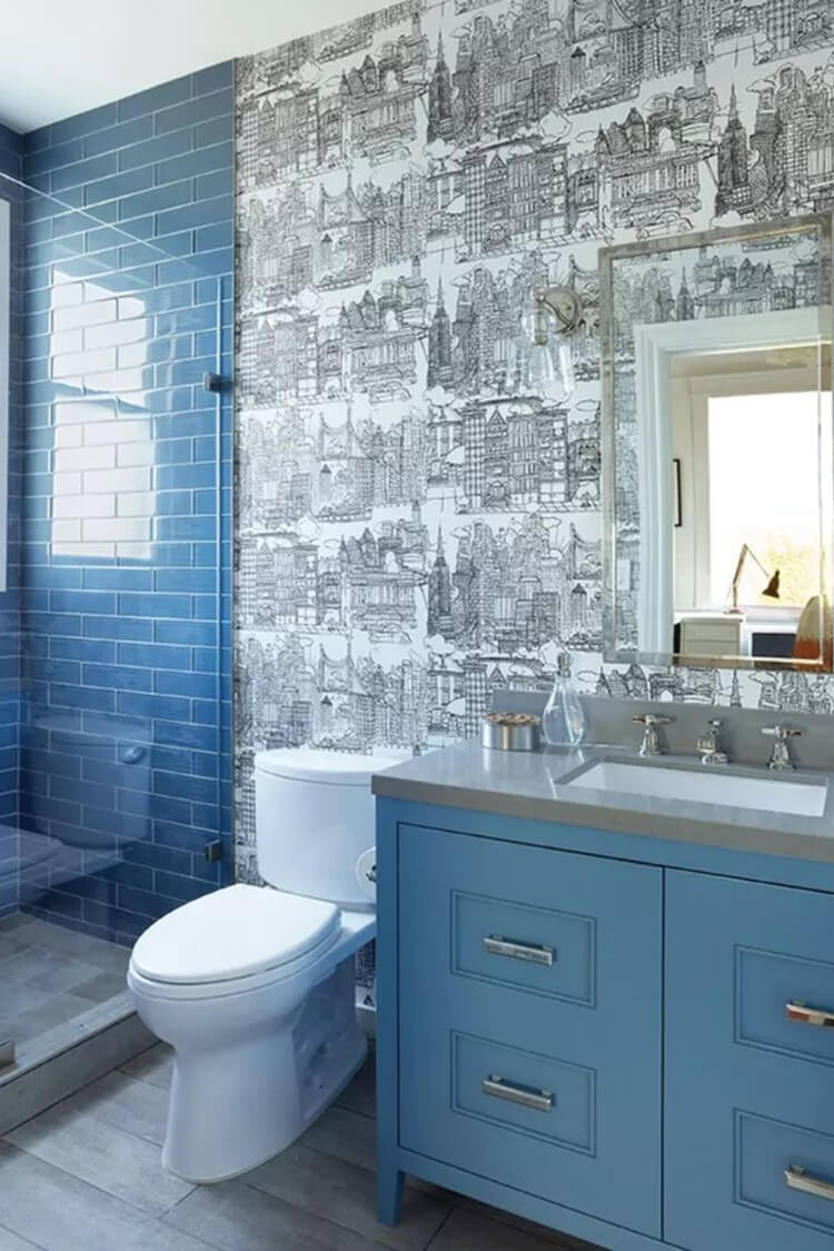 This chic bathroom pairs teal cabinets with white and black accents for a bold, modern look