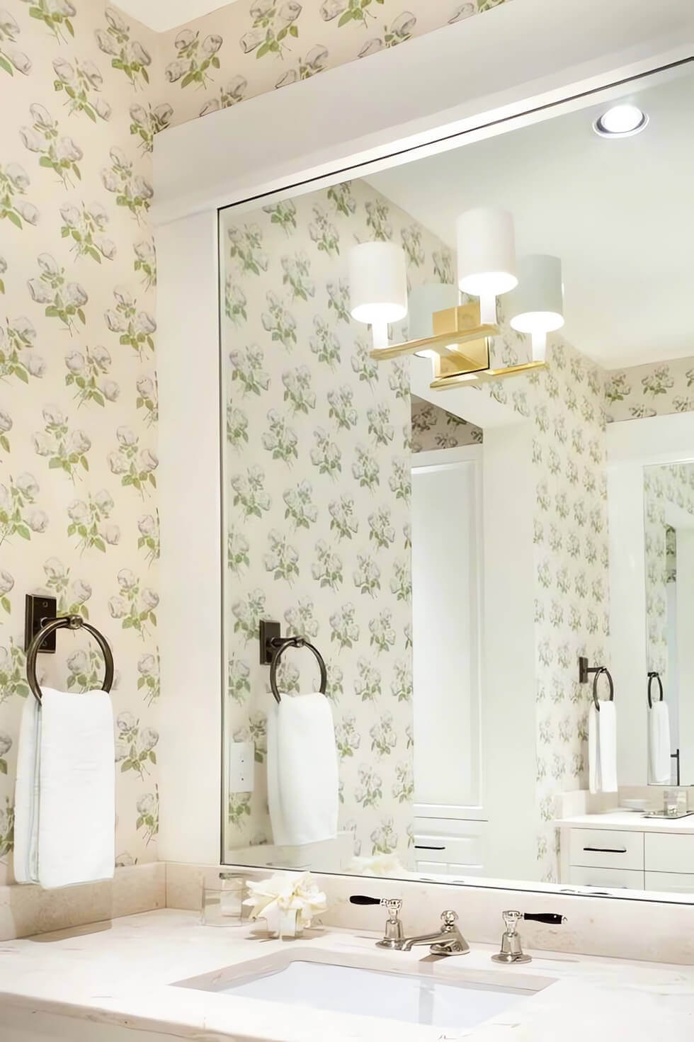 Use a large wall-to-wall mirror to make up for the compactness of a small bathroom