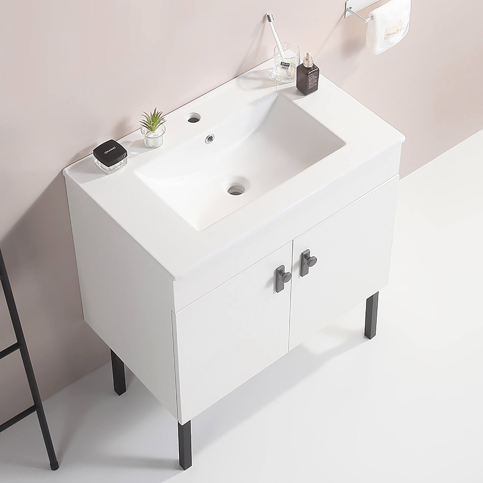 White freestanding bathroom vanity with tall modern metal legs
