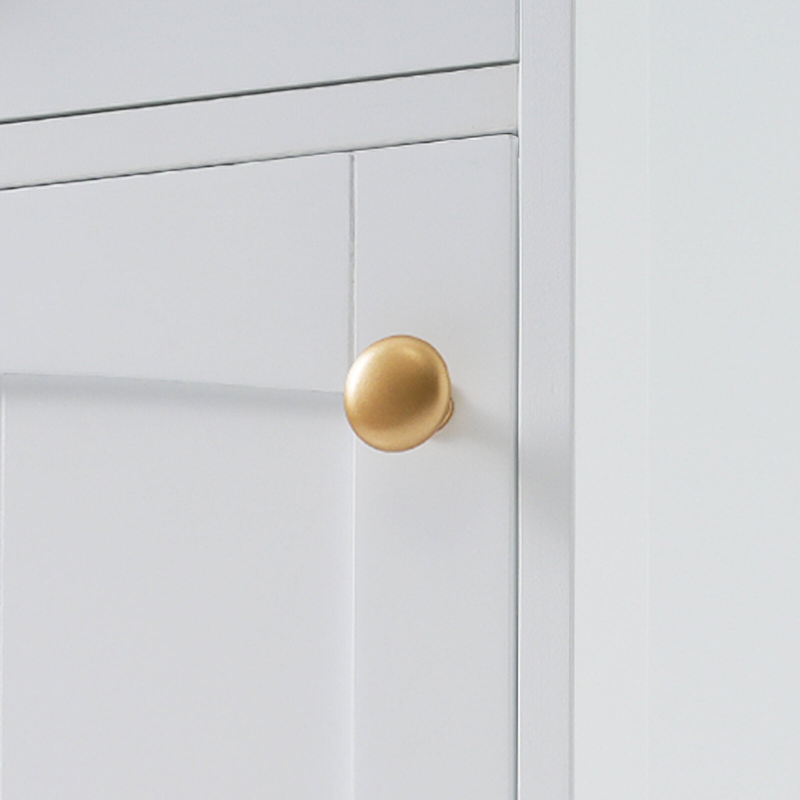 White bathroom storage cabinet with elegant gold round handles