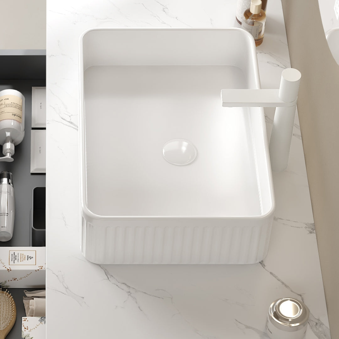 White rectangular ceramic above-counter bathroom sink with smooth interior and vertical ribbed exterior