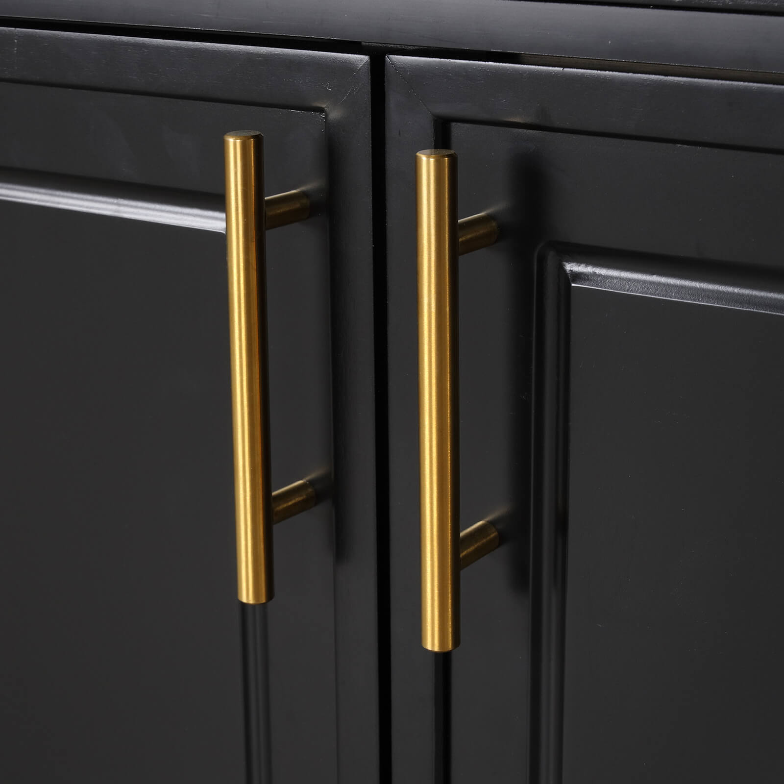gold drawer handles on bold black cabinet