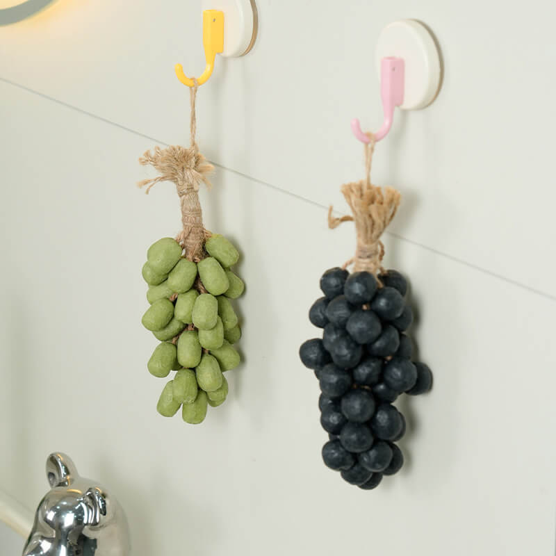 green and Black grape soaps hang together on the wall