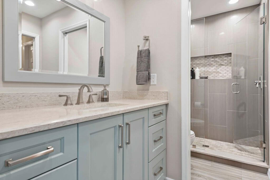 pale blue vanity adds just the right hint of hue without overpowering the space