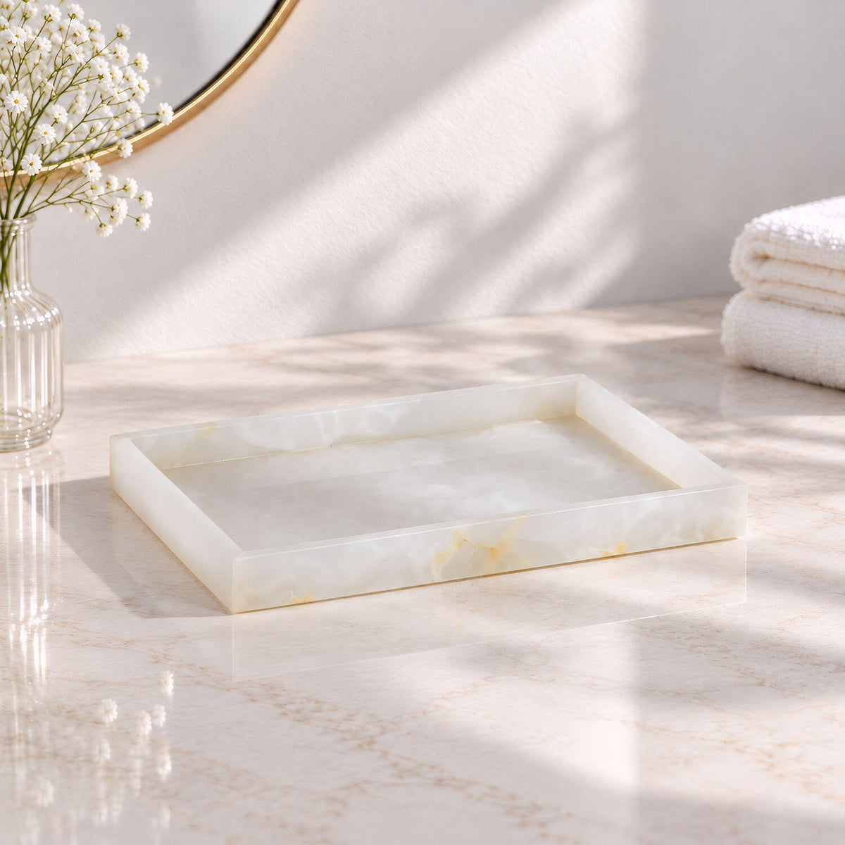 Rectangular white jade marble vanity tray with raised edges on a bathroom countertop