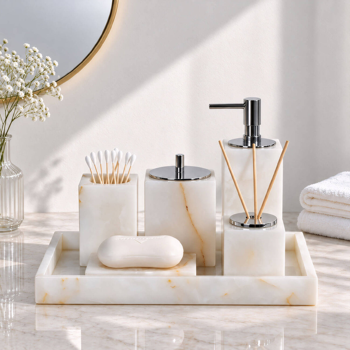 White marble bathroom accessory set with soap dispenser, storage jars and tray, front view