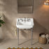 Front bathroom view of a 23-inch white ceramic console sink with chrome legs and a side towel bar beneath a rectangular mirror.