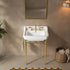 Front bathroom view of a 23-inch white ceramic console sink with gold legs and a side towel bar beneath a rectangular mirror.