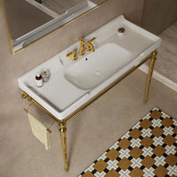 Overhead view of a 48-inch white ceramic console sink with gold legs and a side towel bar in a bathroom.