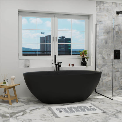 61-inch black freestanding tub in a marble tiled bathroom