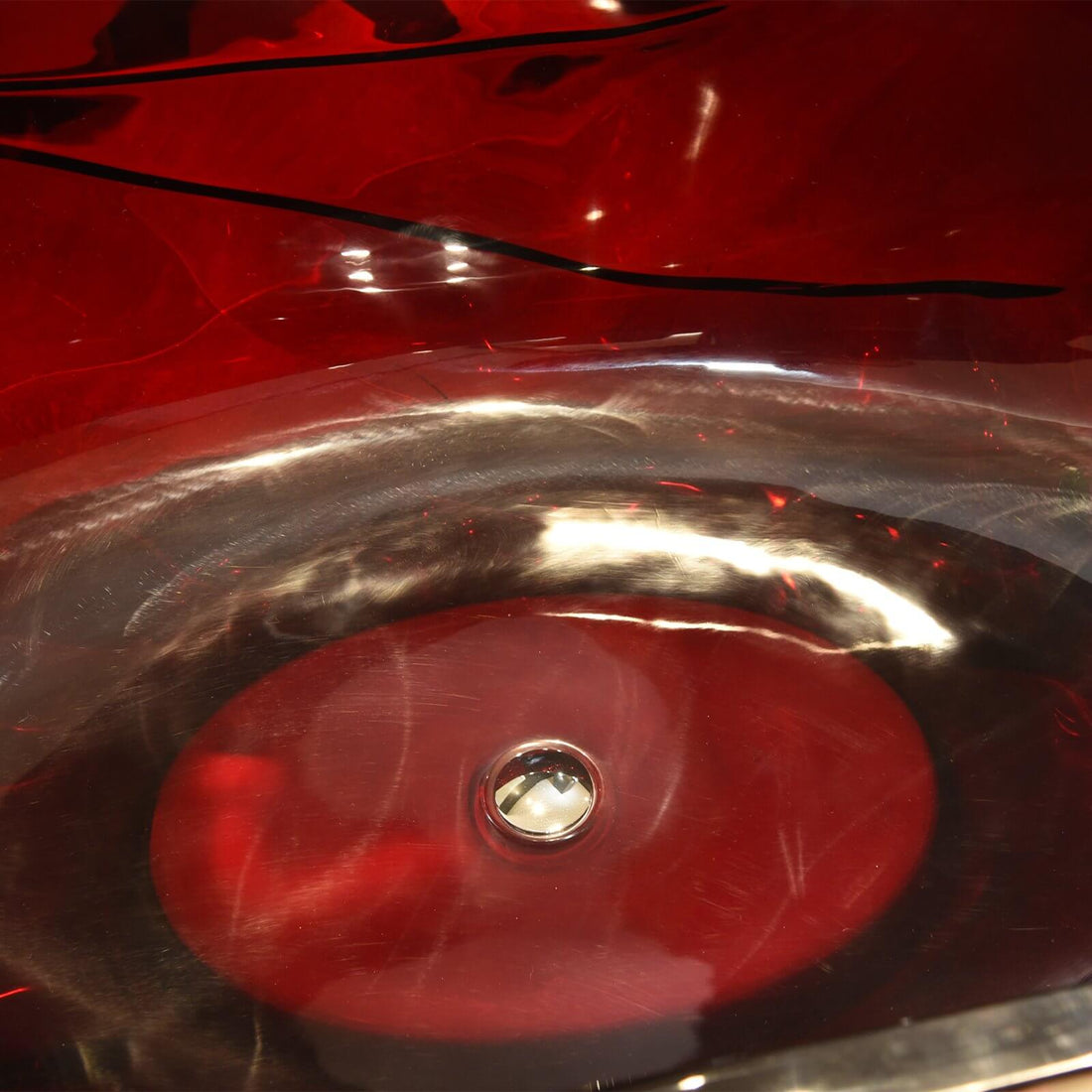 67 in freestanding red crystal bathtub with sculptural design and shimmering red hues