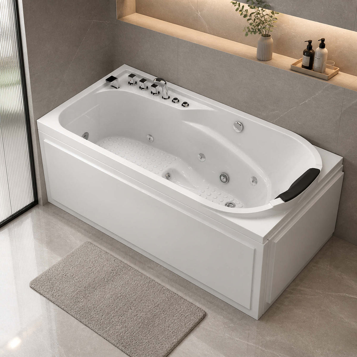 67 inch white acrylic jetted bathtub freestanding in modern gray marble bathroom with wall niche plants and natural stone floor