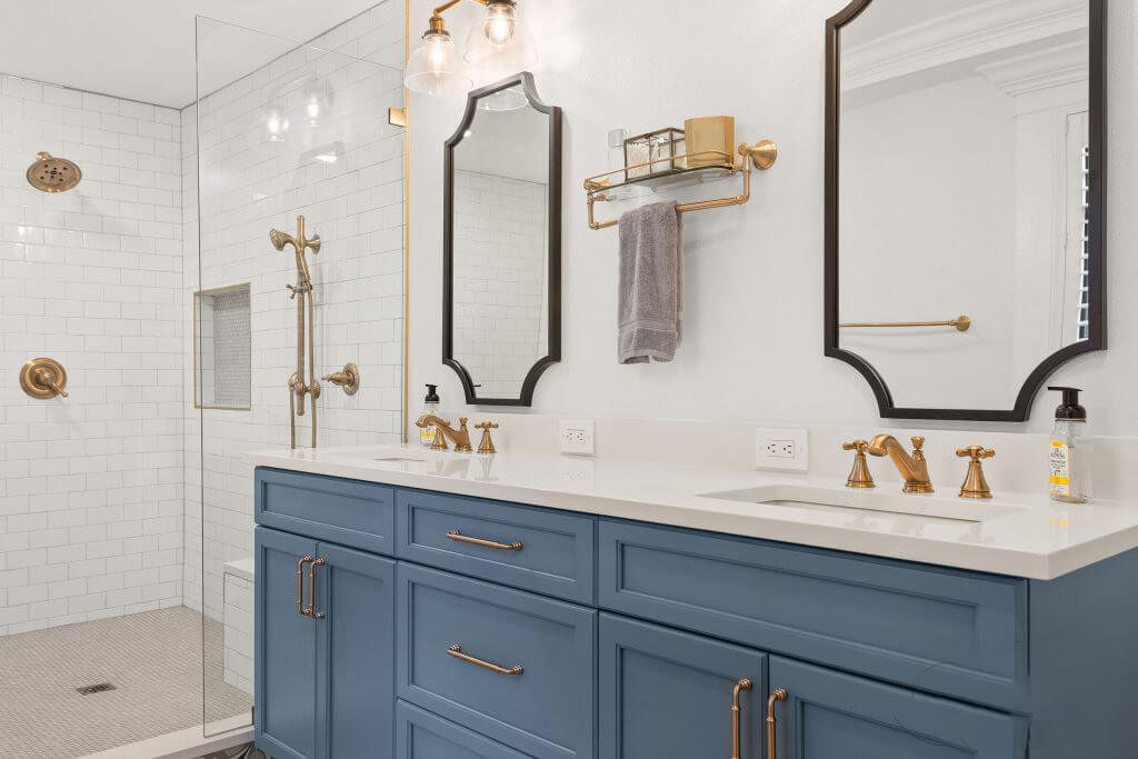 A soft blue-gray vanity in the master bathroom exudes calming elegance