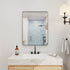 Black framed wall mounted rectangular bathroom mirror with rounded corners