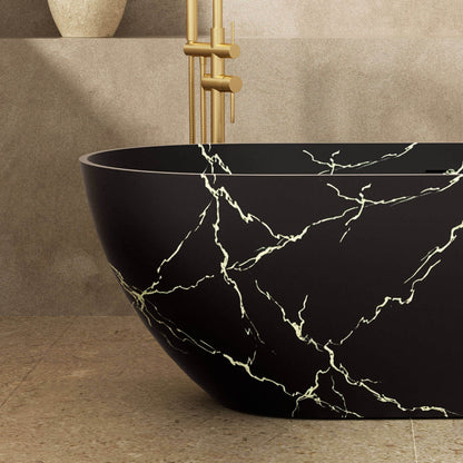 Black soaking tub with elegant gold marble texture close-up