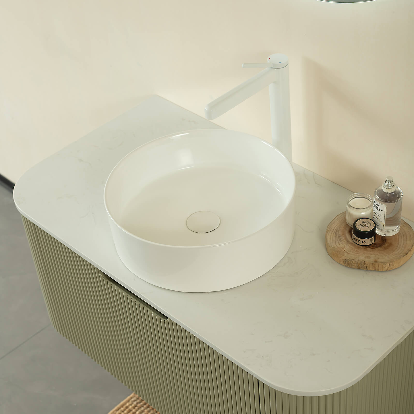Contemporary wall mounted vanity with round sink and recessed handle design