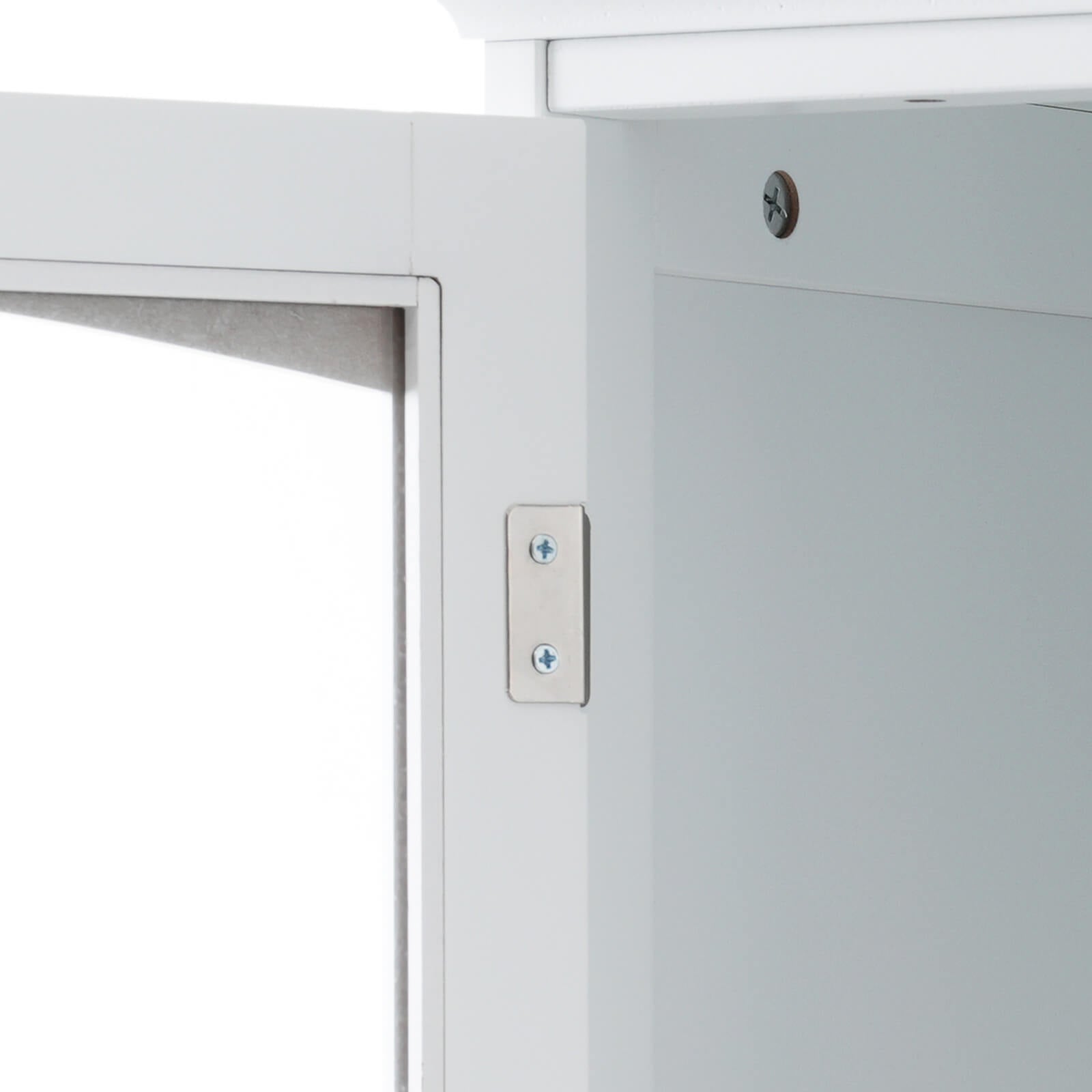Detail of door opening of 63 inch tall white freestanding linen cabinet