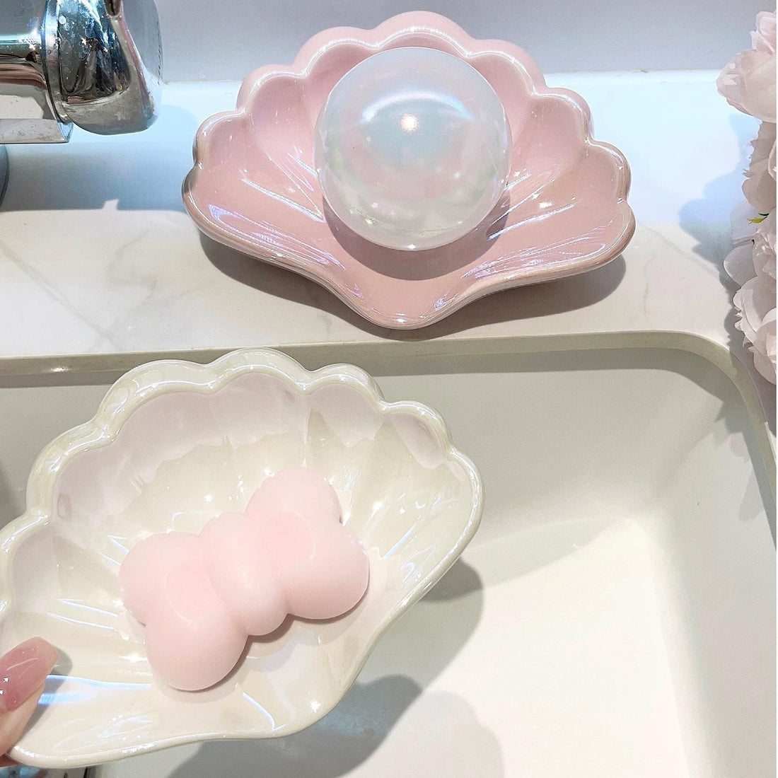 Elegant shell-shaped ceramic soap holder on bathroom sink