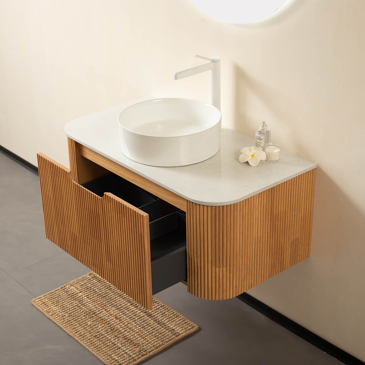 Floating vanity with curved edges and 3D vertical grooves