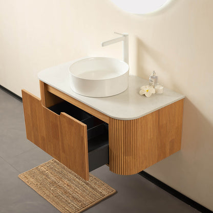 Floating vanity with curved edges and 3D vertical grooves