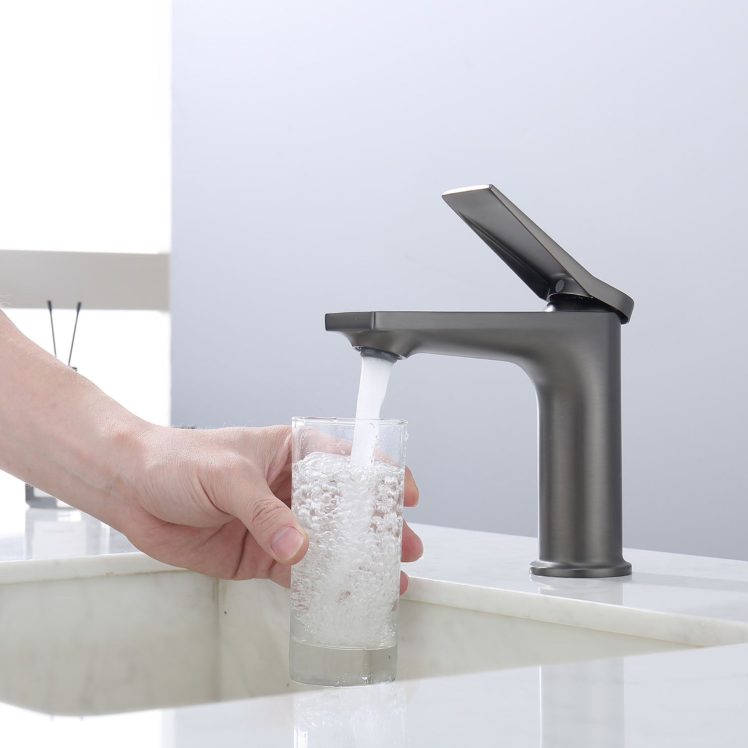 Get a glass of water from a Grey Single Hole Single Handle Bathroom Faucet