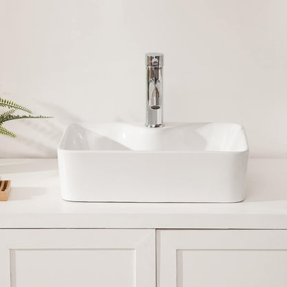 Glossy white bathroom sink reflecting ambient vanity lighting