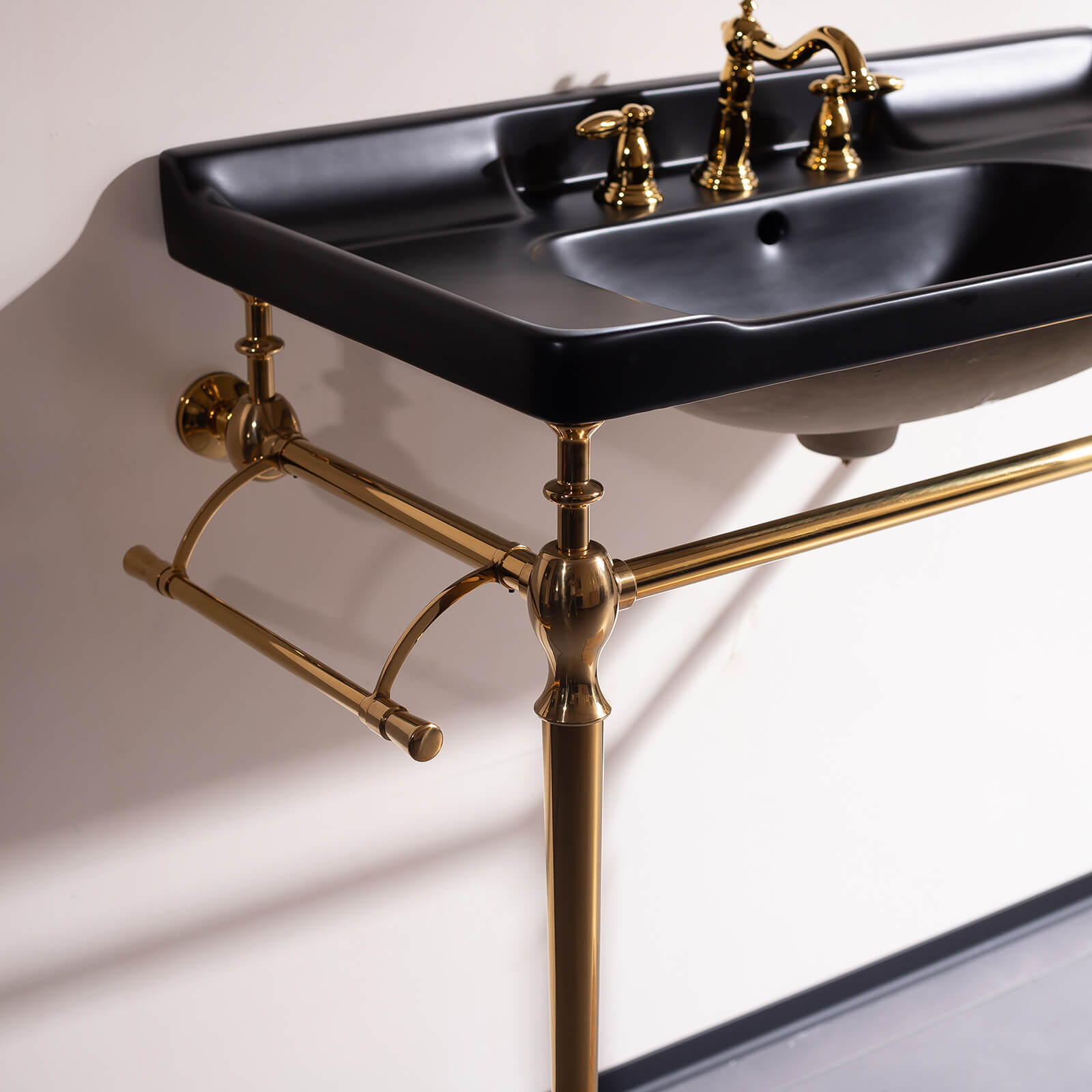 Modern 36 black ceramic vanity sink with integrated towel bars and gold accents in