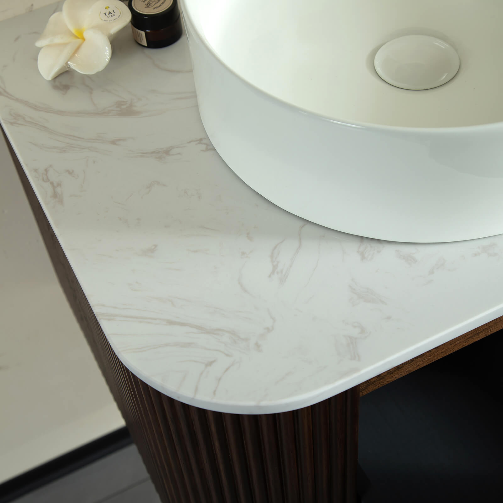 Modern walnut floating vanity with marble look top