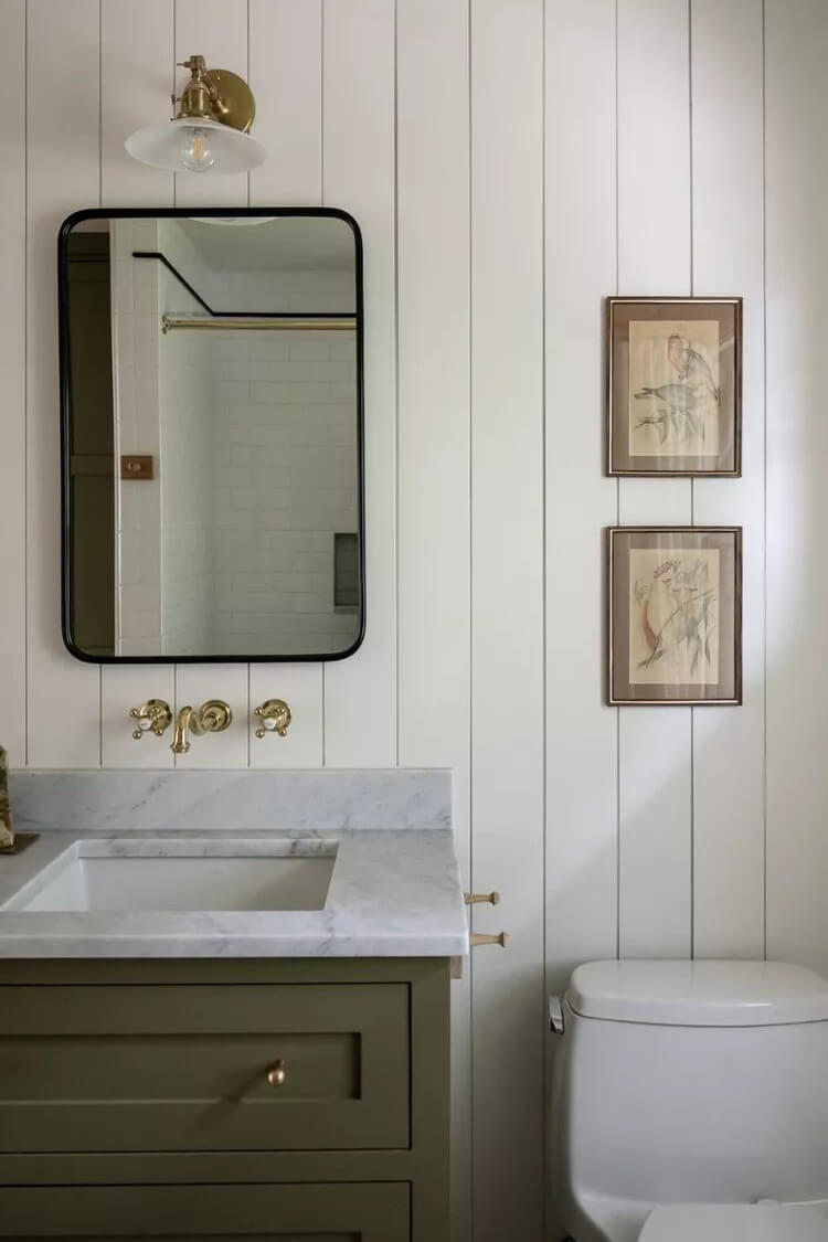 Muted sage cabinets add gentle warmth and a calming vibe to this cozy bathroom refresh