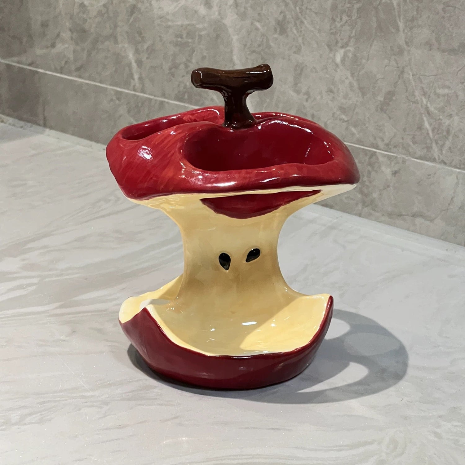 Red apple toothbrush holder with three slots for brushes
