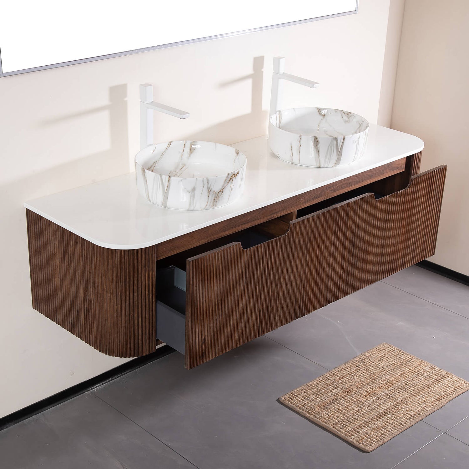 Side angle showing stone veined ceramic basins on walnut vanity