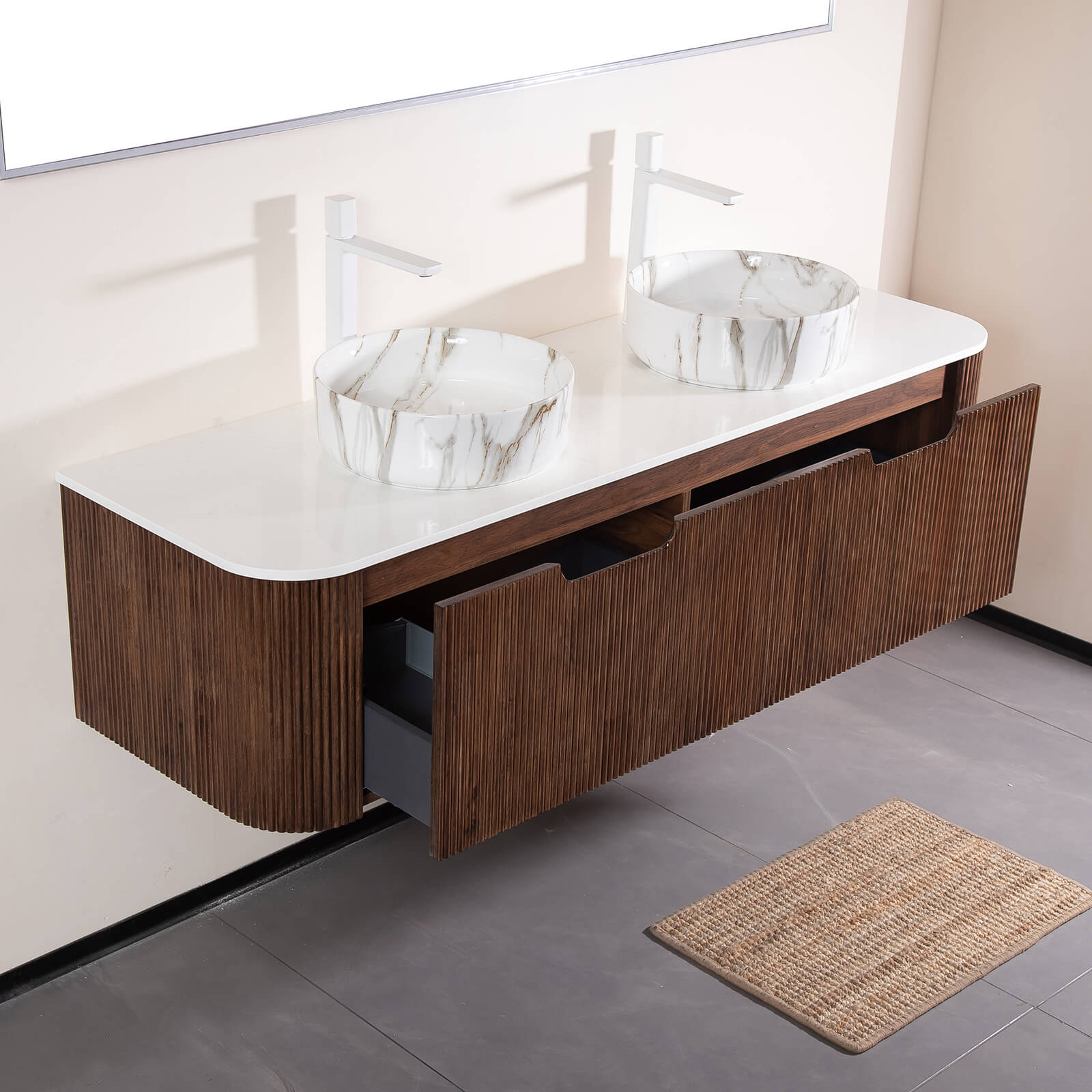 Side angle showing stone veined ceramic basins on walnut vanity