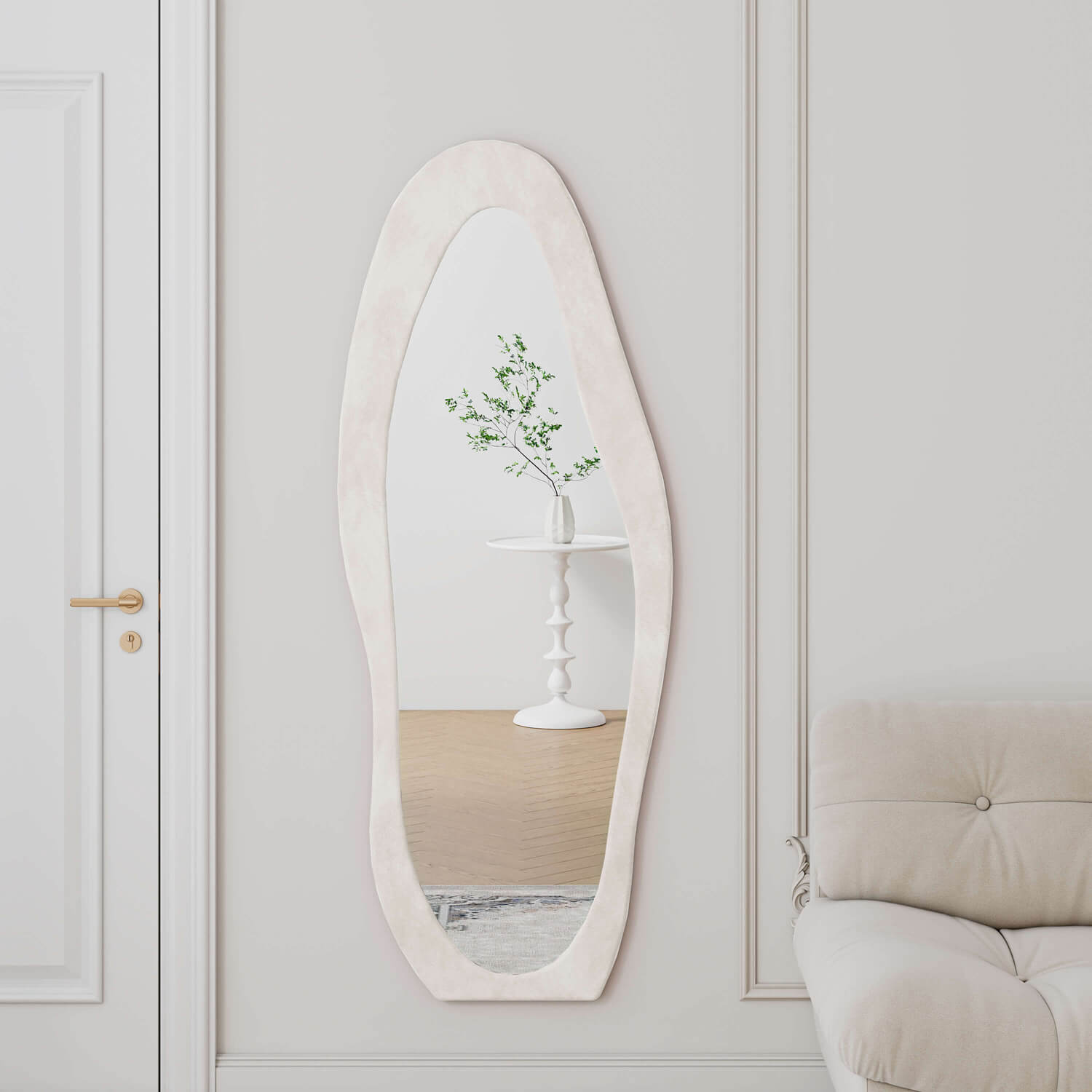 Wall mounted cream organic mirror reflecting plant in French entryway