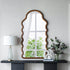 Wall mounted scalloped mirror for modern entryway with table decor