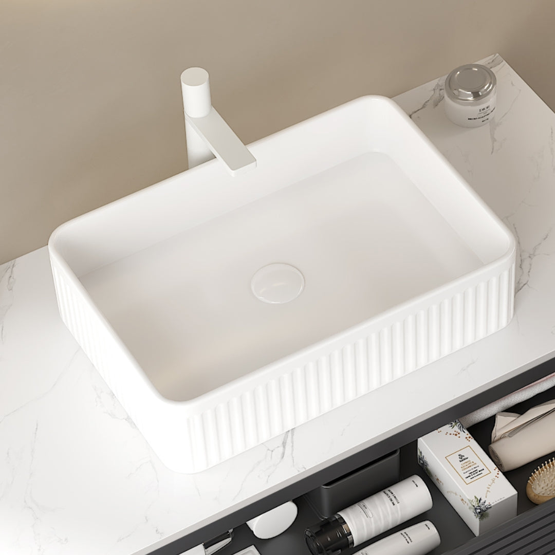 White rectangular ceramic above-counter sink with vertical ribbed exterior and smooth interior