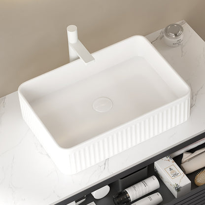 White rectangular ceramic above-counter sink with vertical ribbed exterior and smooth interior