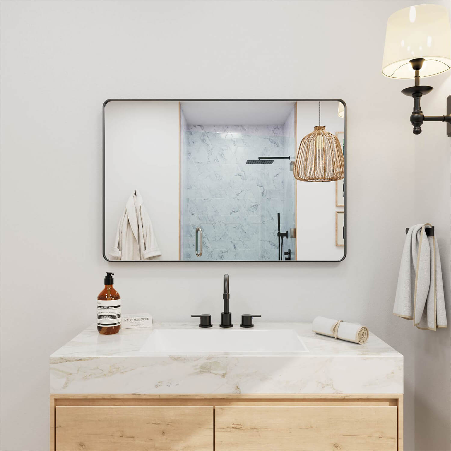 Wide black framed rectangular bathroom mirror with rounded edges