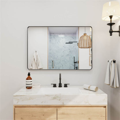 Wide black framed rectangular bathroom mirror with rounded edges