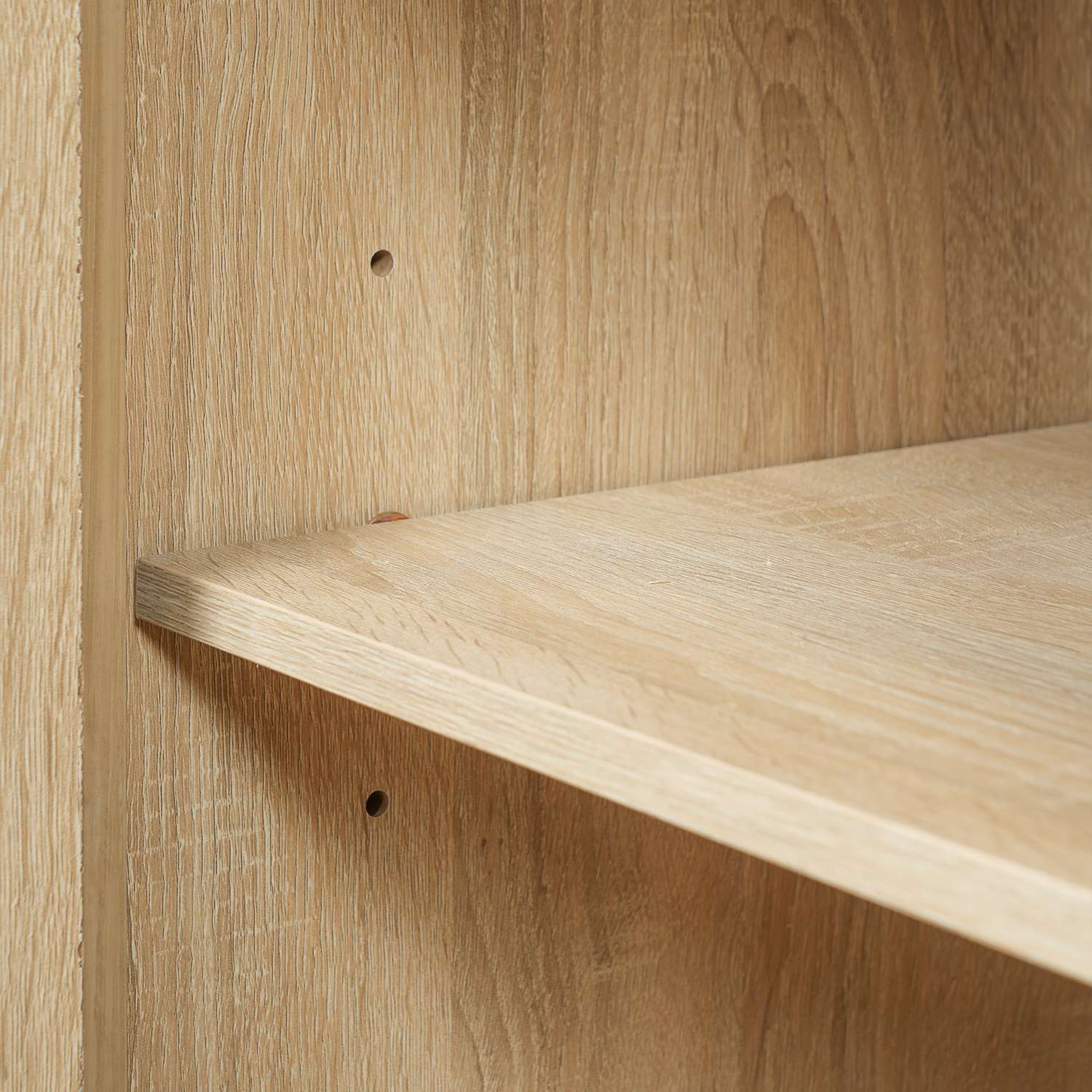 adjustable interior shelf detail inside solid wood bathroom vanity cabinet with rattan doors