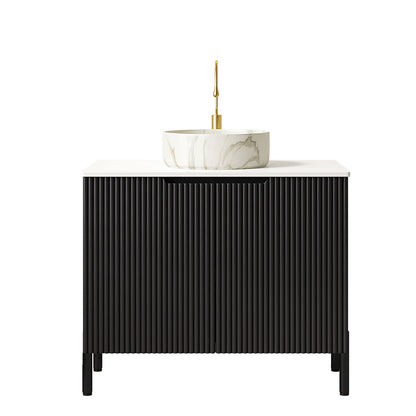 black freestanding vanity with fluted striped cabinet doors